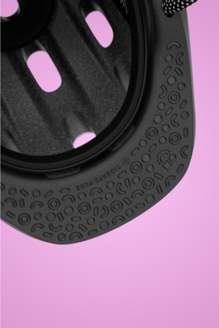 "        
Close-up of the black, patterned, impact-absorbing protective visor on the READY Kids' Helmet on a pink background"